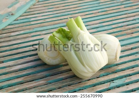 Fresh fennel heads on an old wooden surface
