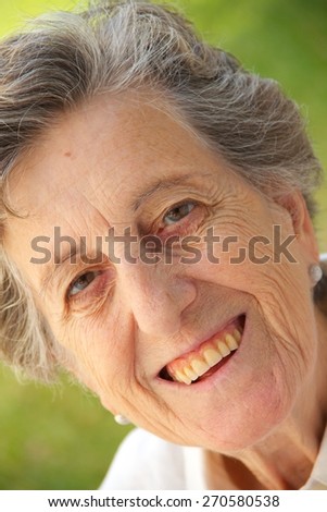 A happy smiling old woman between 70 and 80 years old. Close up.