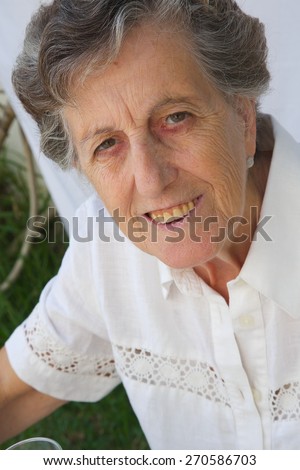 The face of a smiling old woman between 70 and 80 years old. Close up
