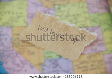 Written text on the paper placed on the map of the United States: \