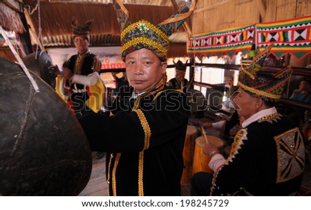 KOTA KINABALU, MALAYSIA - MAY 30 : Traditional musical player in traditional Tindal costume perform during Harvest Festival celebration May 30, 2013 in Kota Kinabalu, Sabah, Malaysia.