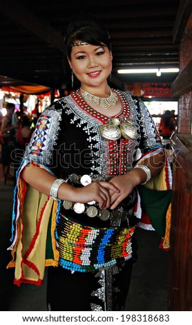 KOTA KINABALU, MALAYSIA - MAY 30 : Dusun Tindal lady in colorful traditional costume poses for the public during Harvest Festival celebration May 30, 2014 in Kota Kinabalu, Sabah, Malaysia.