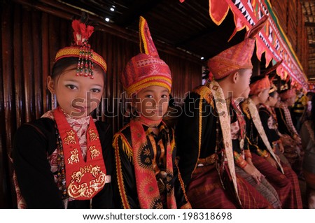 KOTA KINABALU, MALAYSIA - MAY 30 : Dusun Lotud in their traditional costume welcome the public during Harvest Festival celebration May 30, 2013 in Kota Kinabalu, Sabah, Malaysia.