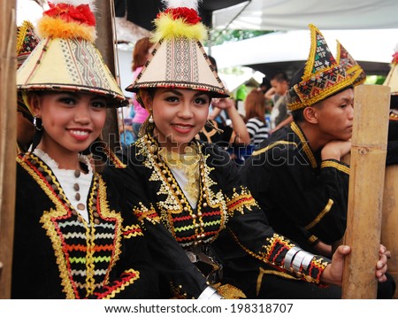 KOTA KINABALU, MALAYSIA - MAY 30 : Kadazan Papar ladies in their traditional costume poses for the public during Harvest Festival celebration May 30, 2014 in Kota Kinabalu, Sabah, Malaysia.