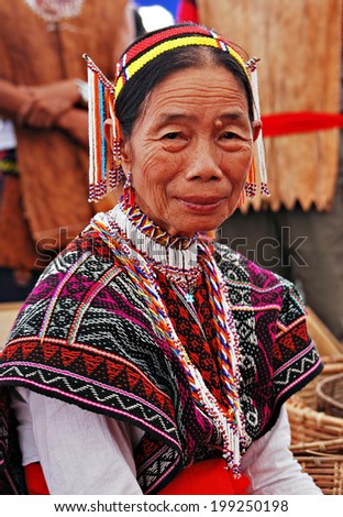 KOTA KINABALU, MALAYSIA - MAY 30 : Dusun Rumanau Leboh lady in traditional costume taking a break after performing for the Harvest Festival celebration May 30, 2014 in Kota Kinabalu, Sabah, Malaysia.