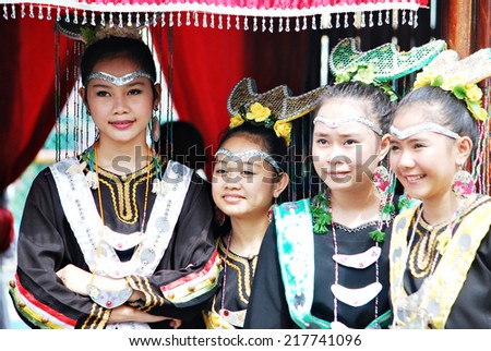 SIPITANG, SABAH, MALAYSIA -.August 30, 2014 : A group of Bisaya young girls in their traditional costume standing at their booth enterance during the GaTa festival in Sipitang Sabah Malaysia.