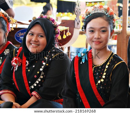 Sipitang, Sabah Malaysia.August 30, 2014 : Two ladies from the Kedayan ethnic of Sabah in their traditional costume smiles to the guests at their booth during GaTa festival in Sipitang Sabah Malaysia.