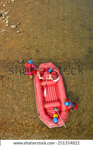 Visitors getting on board of a raft for a rafting experience at Kiulu white water rafting site