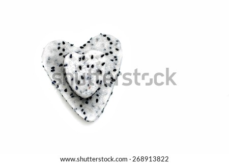 Three heart-shaped dragon fruit on white plate with clean white background. Image has selective focusing and suitable for background purposes only.
