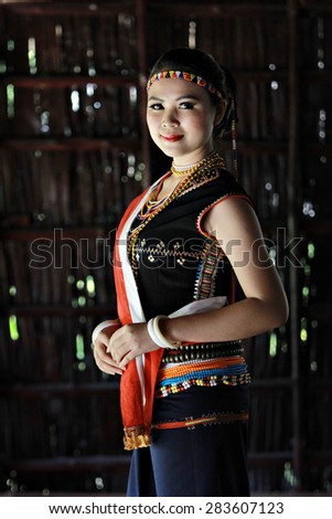 Kota Kinabalu, Sabah Malaysia.May 31, 2015 : Dusun Tobilung girl wearing colorful traditional costume during Pesta Kaamatan or Harvest Festival in Sabah Borneo.Image with shadow using natural lights.