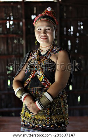 Kota Kinabalu, Malaysia - May 30, 2015: A Rungus woman in traditional costume pose for guests during the State Harvest Festival Celeberation in Kota Kinabalu, Sabah.Image with shadow in natural light.