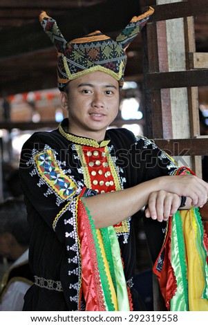 Kota Kinabalu, Sabah Malaysia.May 30, 2015 : Dusun Tindal man in elaborated colorful traditional costume during Pesta Kaamatan or Harvest Festival in Sabah Borneo. Image has shadow from natural light.