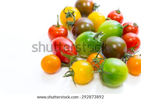 Various cherry tomatoes isolated on white background