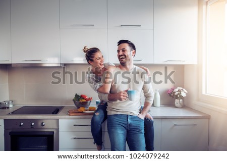 Romantic young couple cooking together in the kitchen,having a great time together.