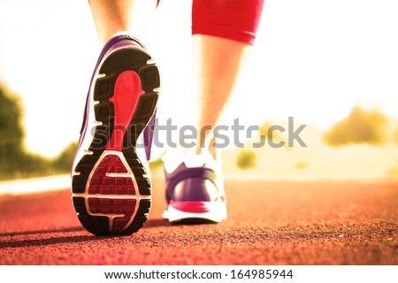 Close up of running shoes in use.Woman fitness sunrise jog workout welness concept