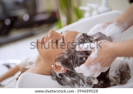 Portrait of women which wash hair in a beauty salon.Hairdresser washing hair.