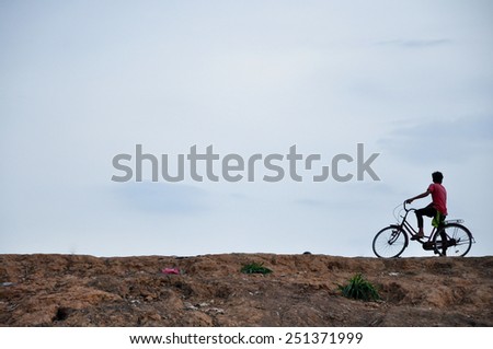Human and old bicycle above the mounds ,Cambodia