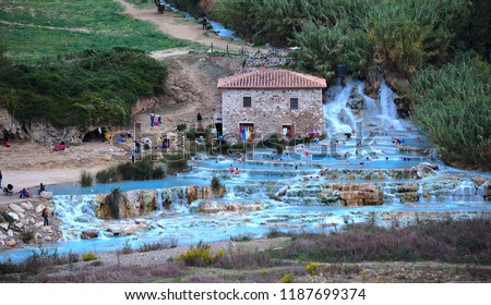 Natural spa with waterfalls and hot springs at Saturnia thermal baths, Grosseto, Tuscany, Italy. People unrecognizable. Natural Spas Saturnia. Autumn, October.