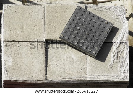 set of tiles to repair the sidewalks by construction workers