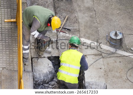 street workers repairing sidewalks and pipelines