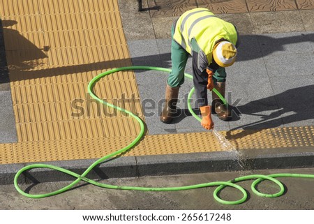 street worker repairing sidewalks and pipelines