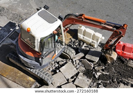 bulldozer excavator machine construction industry picks up debris on city street