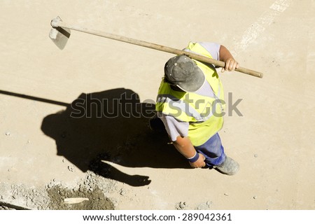 construction worker carrying  hoe for repairing  pipes in the  city street