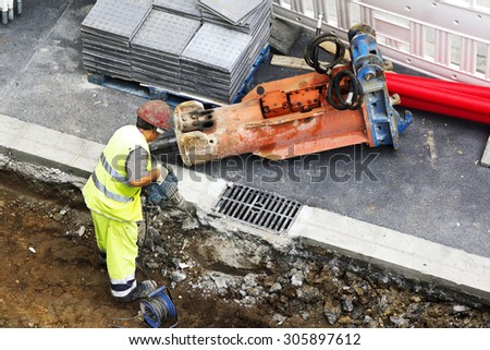 construction worker man  repairing the sewer and water  pipes in the street city