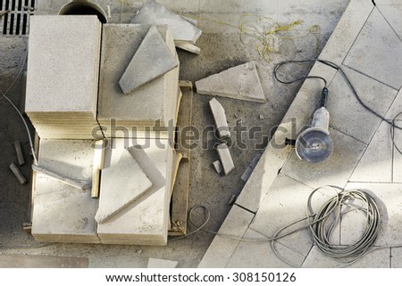 tiles and  utilities  tools for mason  construction workers on a wooden pallet to repair street city