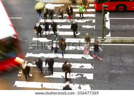 people walking in the crosswalk at  dawn dangerously