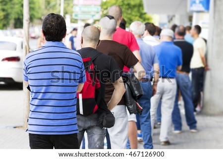 people  queue  in line, selective focus