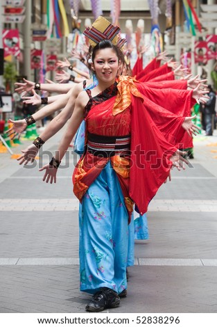 KAGOSHIMA CITY, JAPAN - APRIL 26: Dancers in red and blue costume   perform in a covered street arcade in the Daihanya Festival April 26, 2009  in Kagoshima City, Japan.