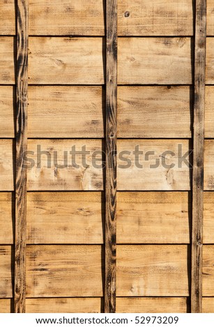 The wood siding of an old style Japanese house. The wood is new but had been burned to give the appearance of being older.