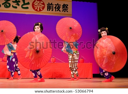 KAGOSHIMA CITY, JAPAN - OCTOBER 27:  Japanese dancers in traditional costume perform with umbrellas onstage in the Taniyama Furusato Matsuri dance festival  October 28, 2007 in Kagoshima City, Japan.