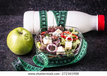 Fitness salad and measuring tape