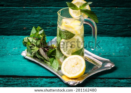 refreshing citrus lemonade,summer drink. Lemonade with fresh lemon on wooden table