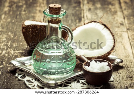 Coconut and oil on wooden table .Vintage filter. Organic and healthy food concept .Beauty and SPA treatment product.