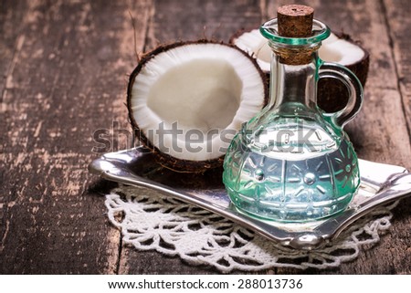 Coconut and oil on wooden table .Vintage filter. Organic and healthy food concept .Beauty and SPA treatment product.