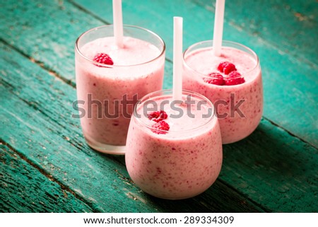 fresh raspberry smoothie on a wooden background. Summer detox drink and refreshment organic concept.Vintage filter.