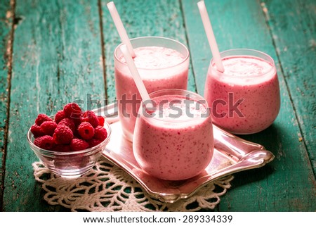 fresh raspberry smoothie on a wooden background. Summer detox drink and refreshment organic concept.Vintage filter.