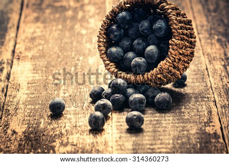 berries in basket on wooden vintage table,healthy food.