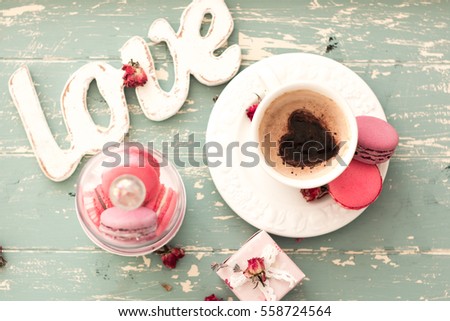 romantic breakfast in bed. Cappuccino ,strawberry macaroons ,gift box on wooden blue table. Valentine\'s day concept