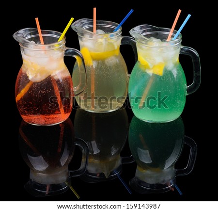 Three kinds of lemonade on black reflecting background