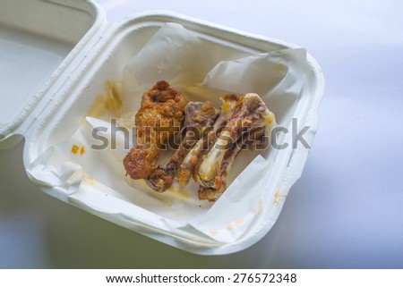 Chicken bones in carton