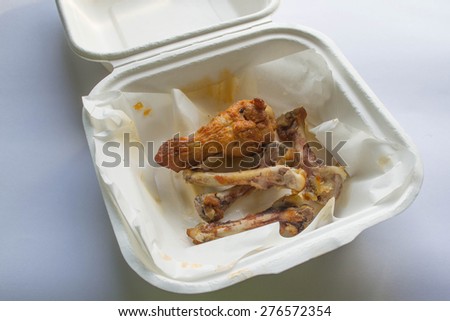 Chicken bones in carton