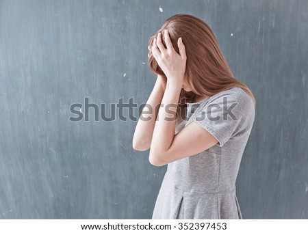Young beautiful woman with long light hair in bad mood, crying, feels bad and in depression