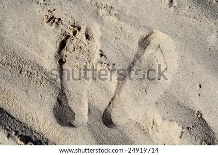 imprints of feet on sand