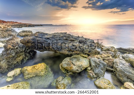Surreal landscape heap of stones in the sea shot with a long exposure