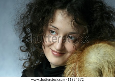 The portrait a young woman with fur of the fox.