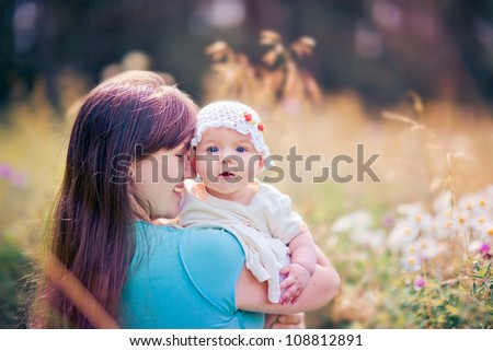 Summer outdoor Portrait of happiness mother with baby girl